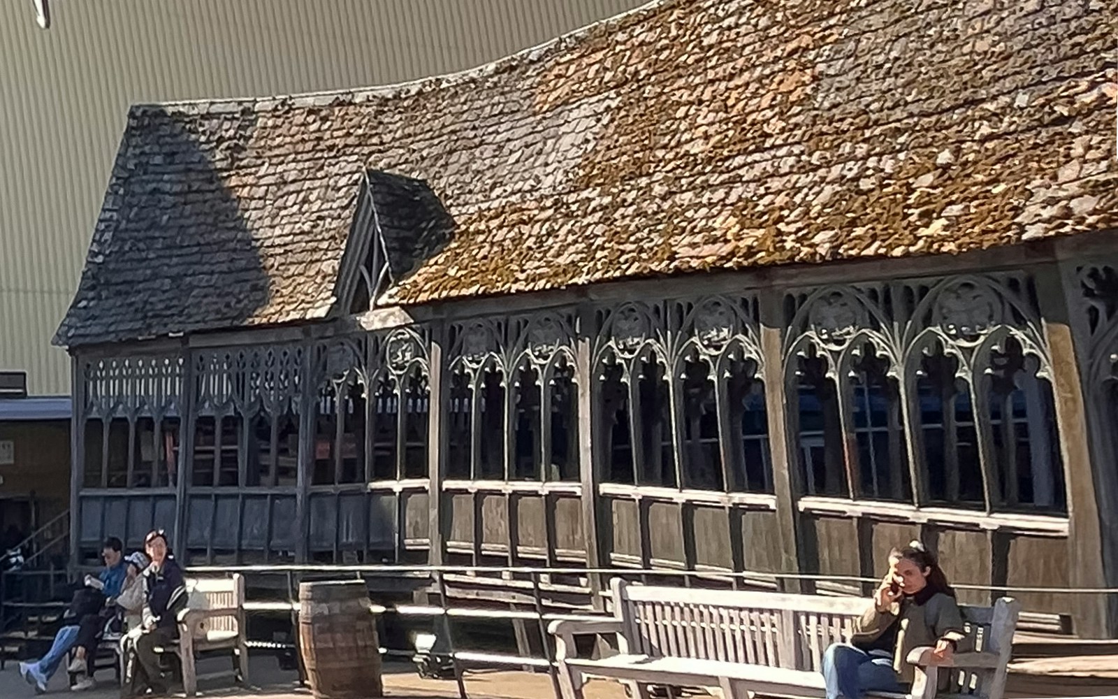 Hogwarts Bridge at Harry Potter Studio Tour in London with visitors seated nearby.