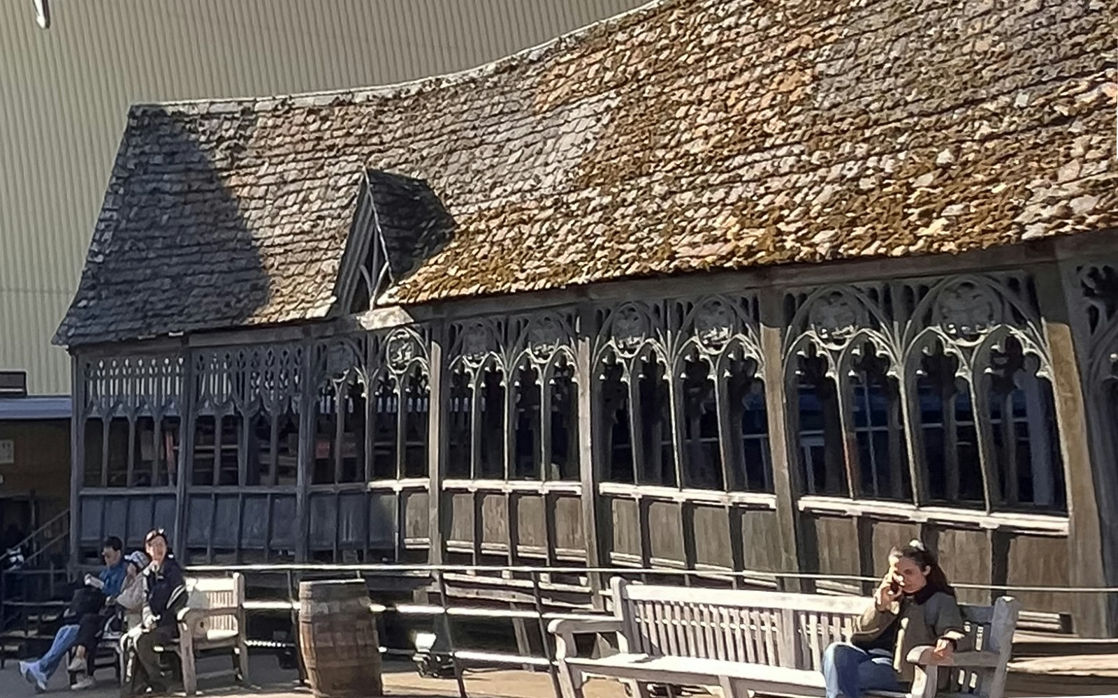 Hogwarts Bridge at Harry Potter Studio Tour in London with visitors seated nearby.