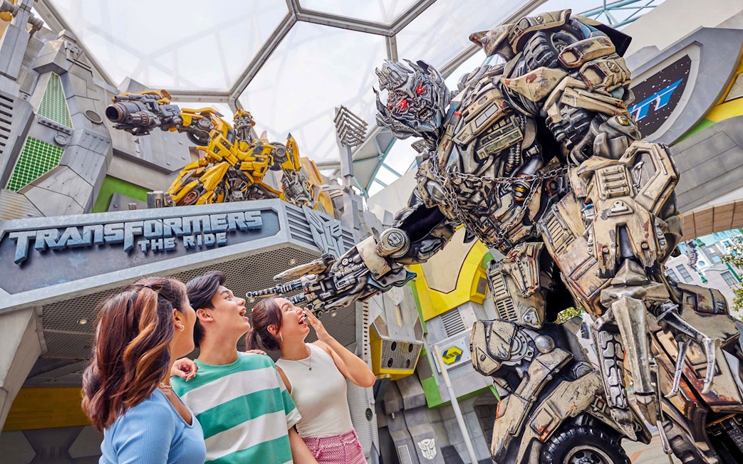 Visitors interacting with a Transformer character at Transformers Ride, Universal Studios Singapore.
