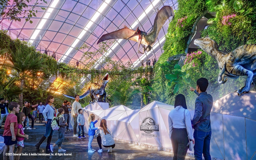 People exploring dinosaur exhibits at Jurassic World in Gardens by the Bay.