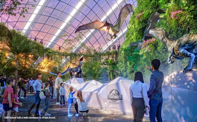 People exploring dinosaur exhibits at Jurassic World in Gardens by the Bay.