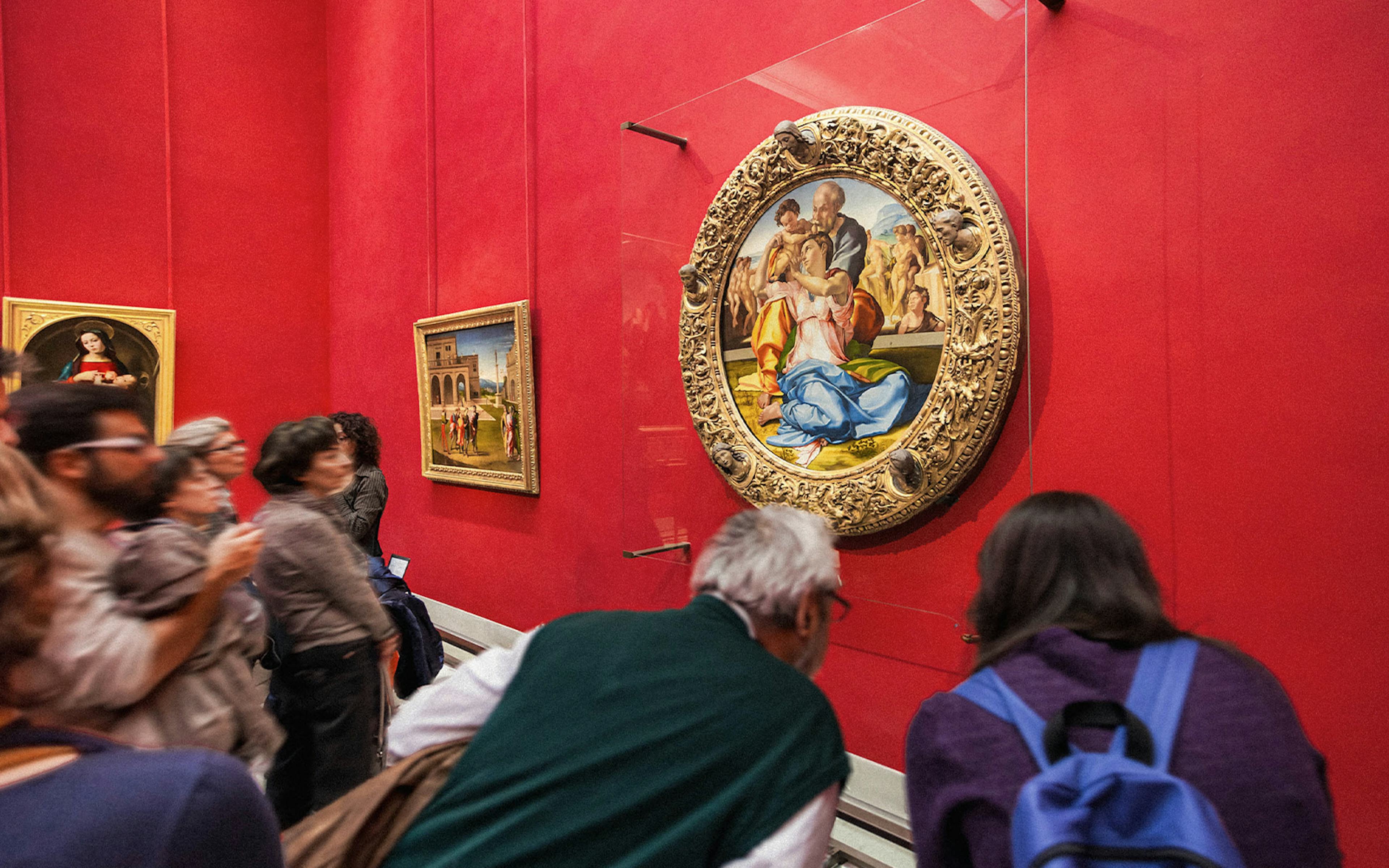 Tourists viewing Renaissance paintings at the Uffizi Gallery, Florence, Italy.