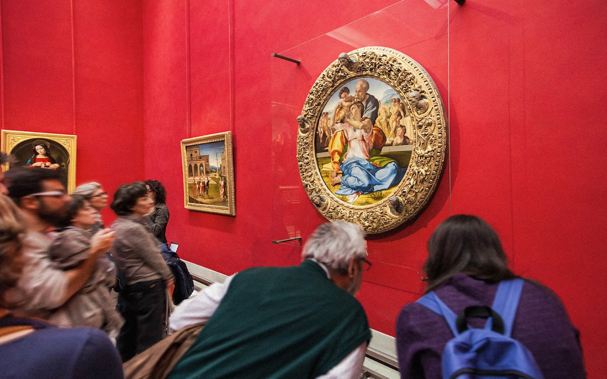 Tourists viewing Renaissance paintings at the Uffizi Gallery, Florence, Italy.
