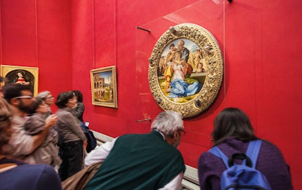 Tourists viewing Renaissance paintings at the Uffizi Gallery, Florence, Italy.
