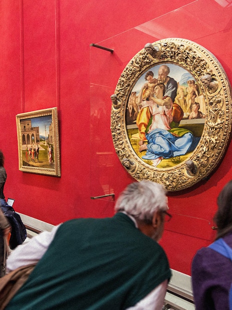 Tourists viewing Renaissance paintings at the Uffizi Gallery, Florence, Italy.