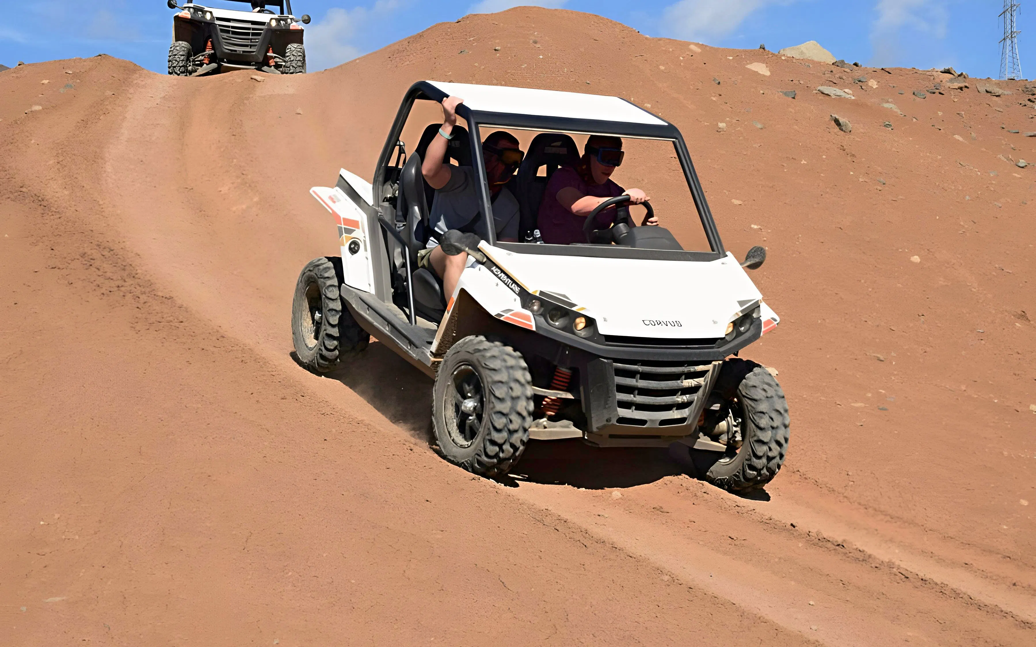 Off-road buggy descending sandy hill in Gran Canaria.