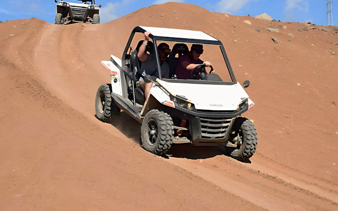 Off-road buggy descending sandy hill in Gran Canaria.