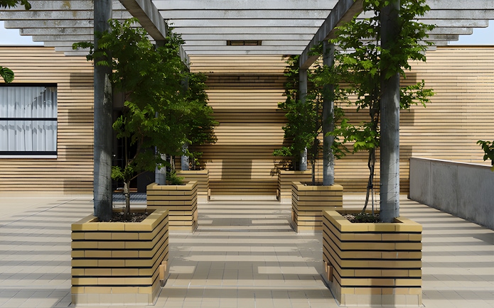 Villa Cavrois entrance with modern architecture and lined planters, France.