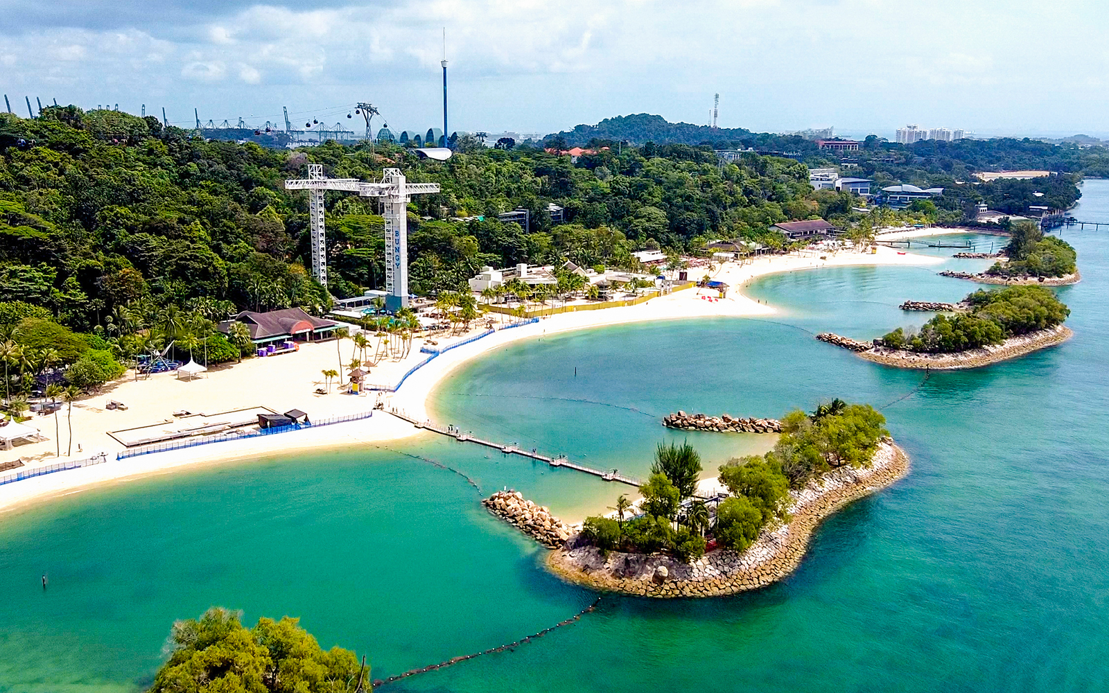 Sentosa skybridge overlooking beaches and lush greenery in Singapore.