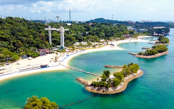 Sentosa skybridge overlooking beaches and lush greenery in Singapore.