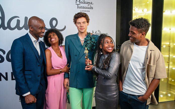 Group posing with wax figure at Madame Tussauds London.
