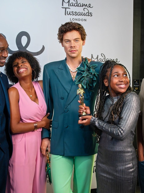 Group posing with wax figure at Madame Tussauds London.