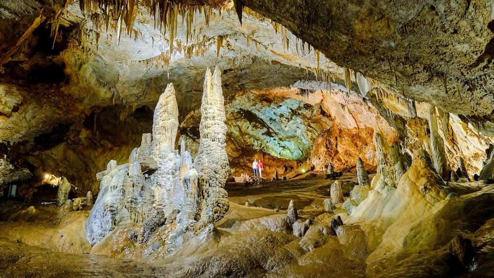 Tourists exploring stalagmites and stalactites inside Lipa Cave, Cetinje.