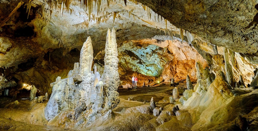 Tourists exploring stalagmites and stalactites inside Lipa Cave, Cetinje.