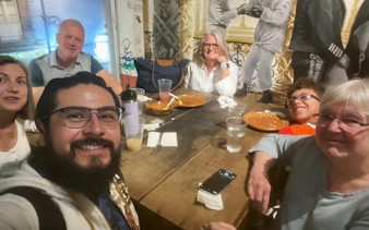 Group enjoying a meal at a table in Lucha Libre Arena Mexico.