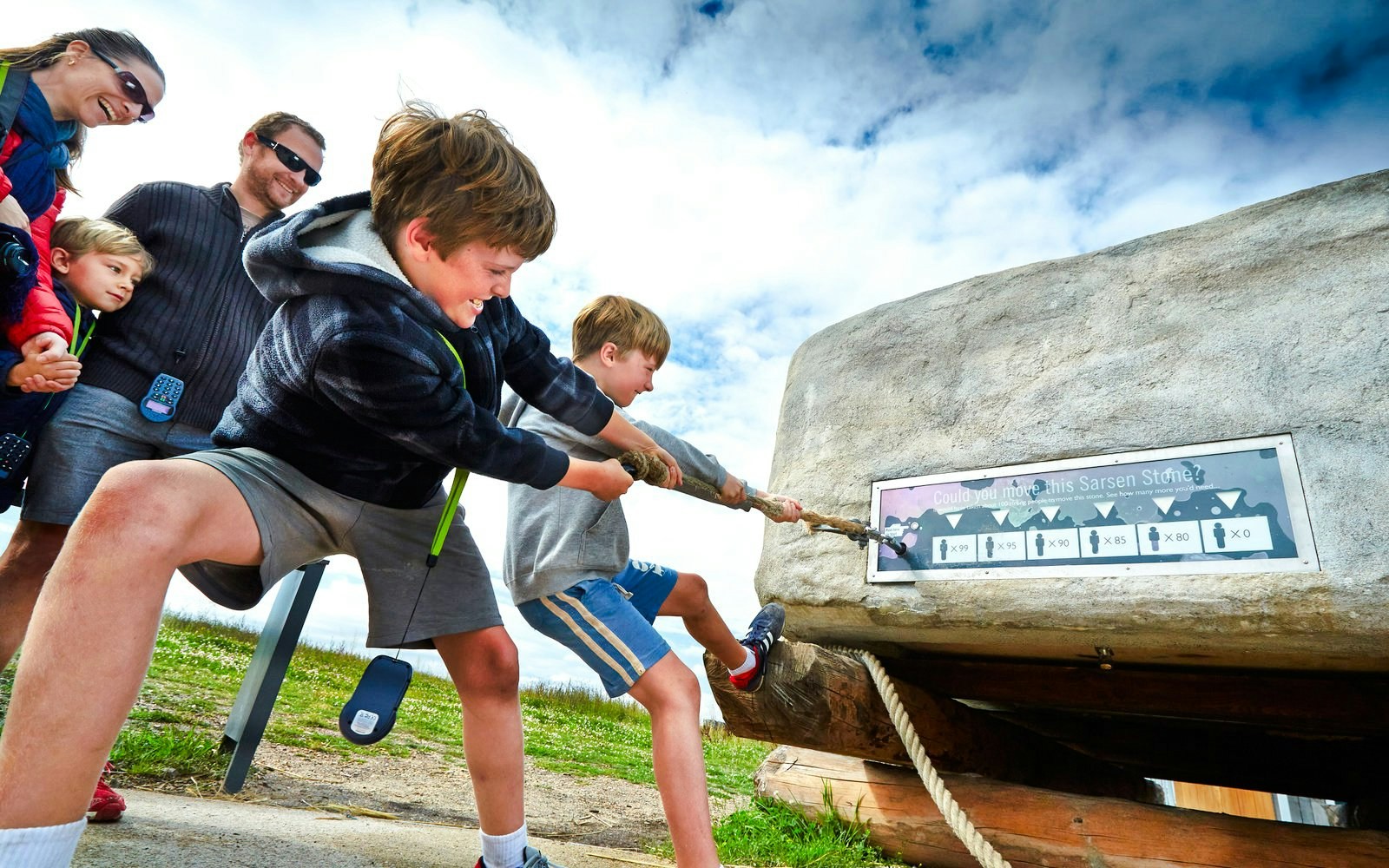 Kids pulling rope at Stonehenge Visitor Center exhibit.
