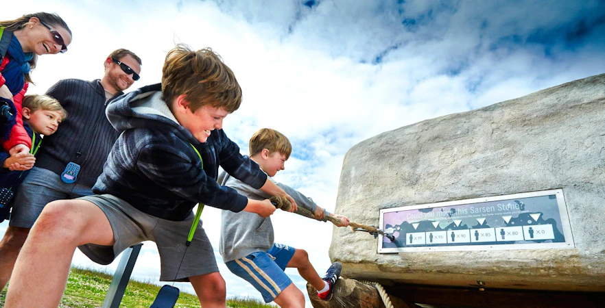Kids pulling rope at Stonehenge Visitor Center exhibit.