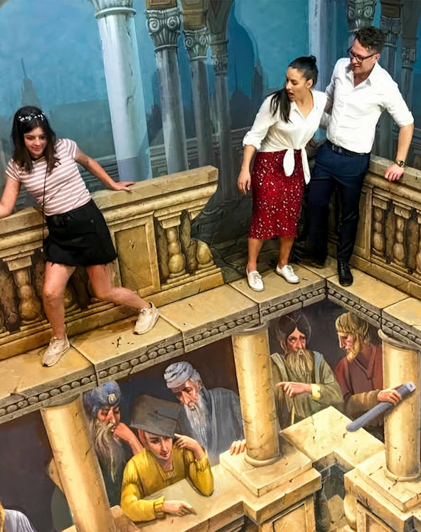 Visitors interacting with 3D illusion art at ArtVo Trick-Art Gallery.
