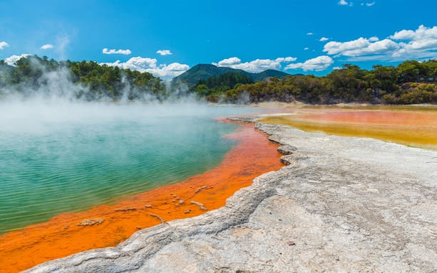 Champagne Lake's vibrant colors and geothermal steam at Rotorua Wai-O-Tapu, New Zealand.