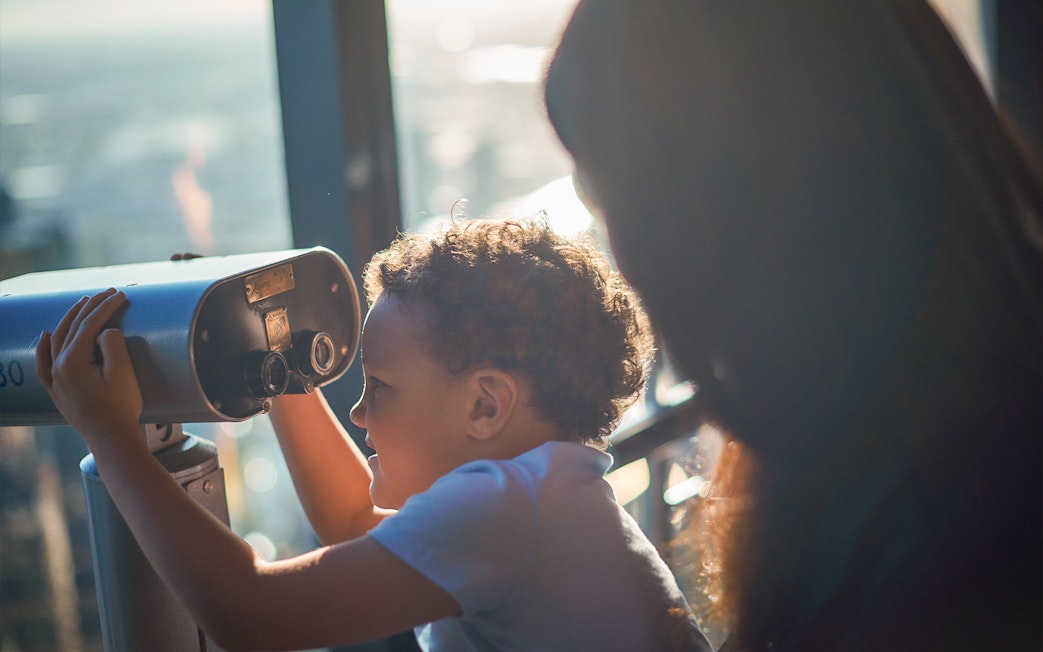 Child using a telescope at Melbourne Skydeck, Eureka Tower.