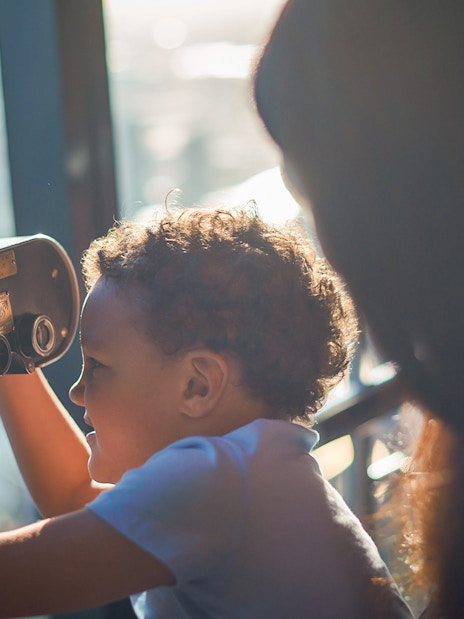 Child using a telescope at Melbourne Skydeck, Eureka Tower.