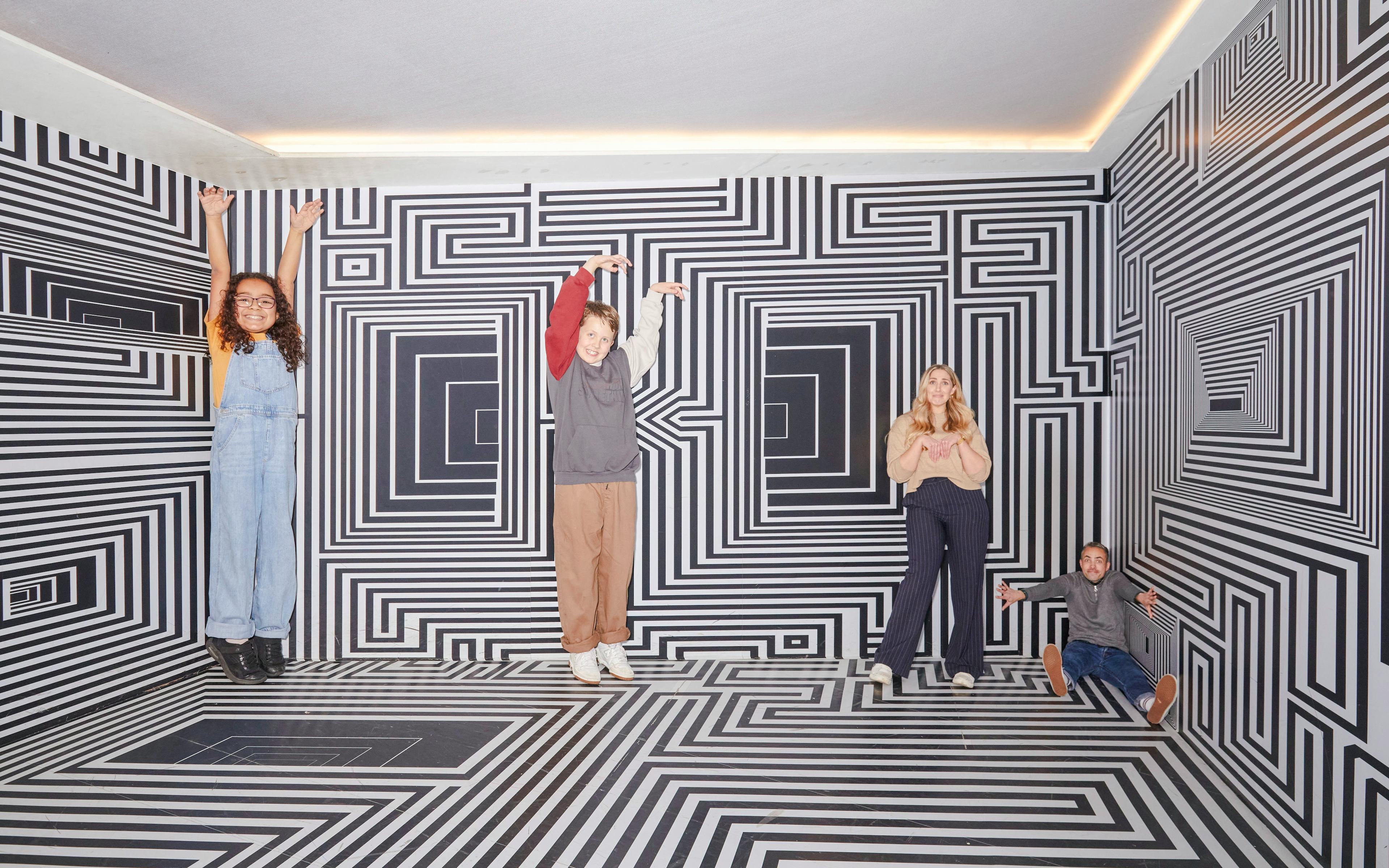Guests interacting with optical illusions at the Twist Museum in London.