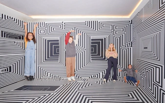Guests interacting with optical illusions at the Twist Museum in London.