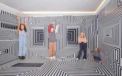 Guests interacting with optical illusions at the Twist Museum in London.