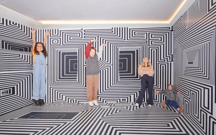 Guests interacting with optical illusions at the Twist Museum in London.