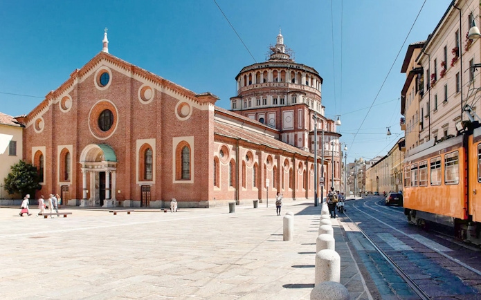 Church of Santa Maria delle Grazie in Milan with tram passing nearby.
