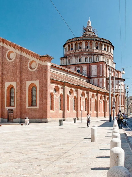 Church of Santa Maria delle Grazie in Milan with tram passing nearby.