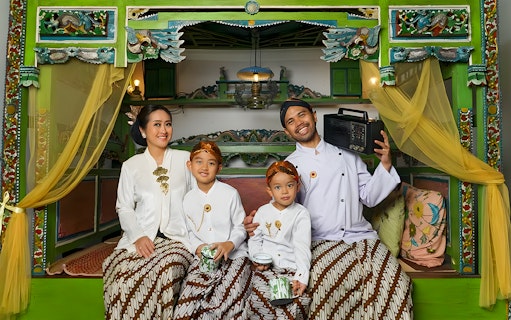 Family in traditional Balinese attire at Asana Artseum, Garuda Wisnu Kencana, Bali.