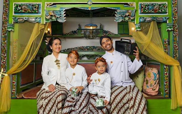 Family in traditional Balinese attire at Asana Artseum, Garuda Wisnu Kencana, Bali.