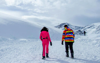 Tourists walking in snow at Valle Nevado ski resort, Chile.
