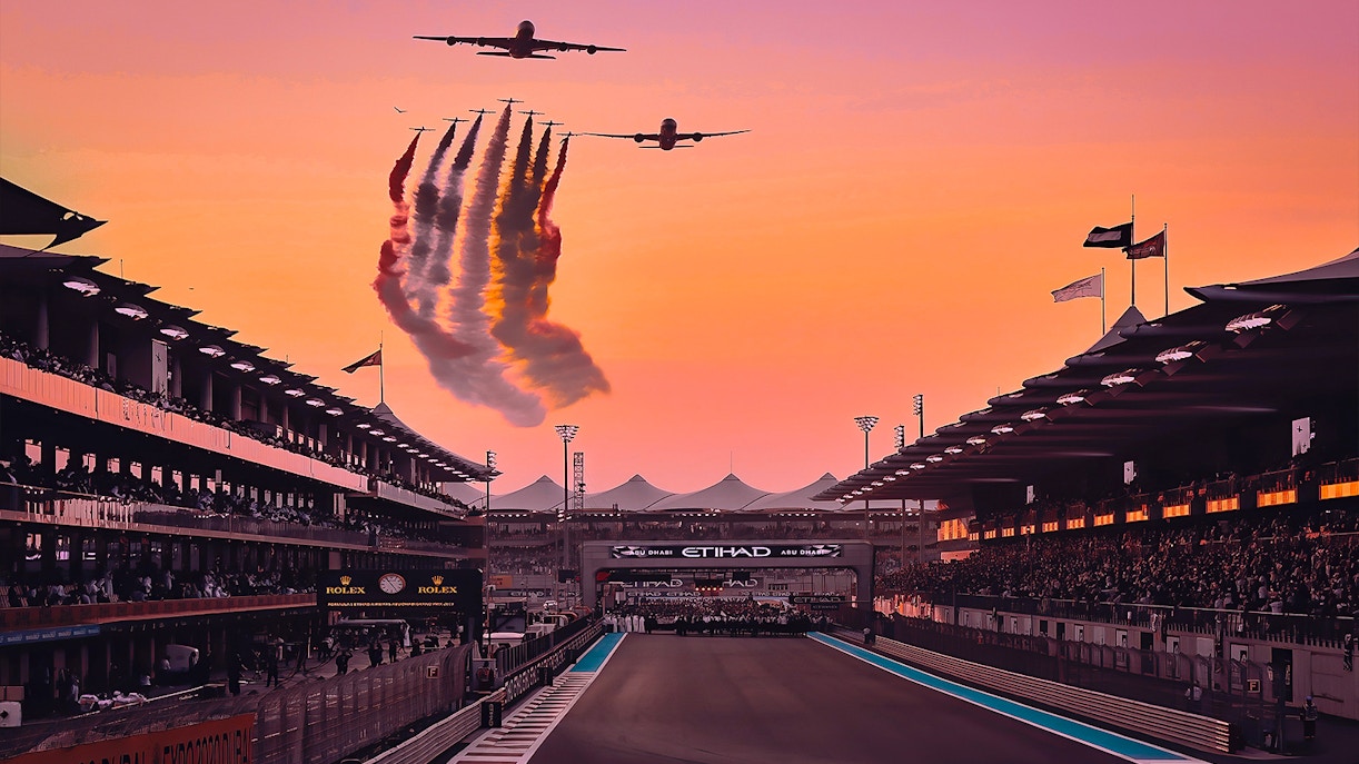 Airplanes flying over Yas Marina Circuit at sunset during Abu Dhabi Grand Prix.