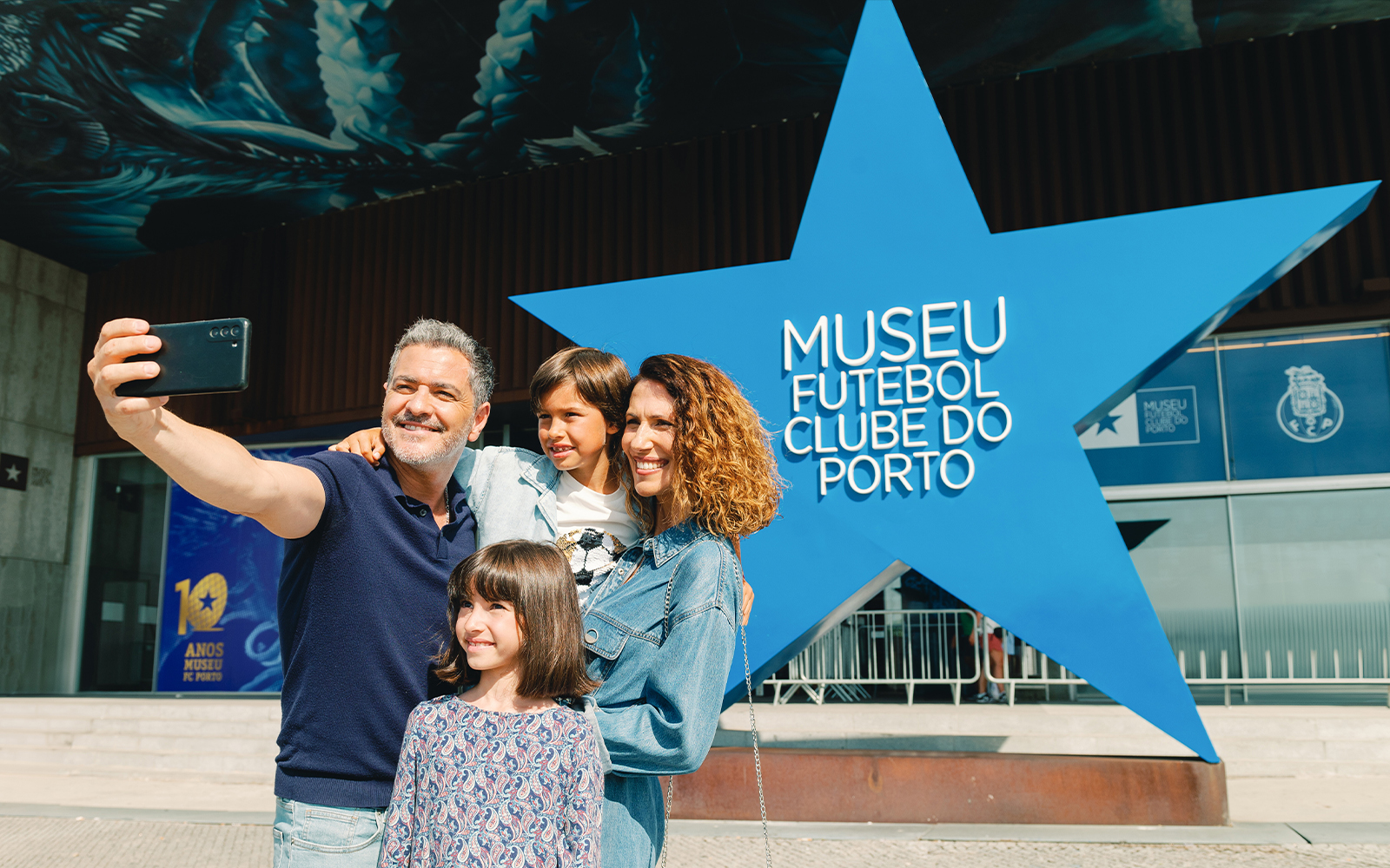 Visitors taking a selfie outside FC Porto Museum entrance.
