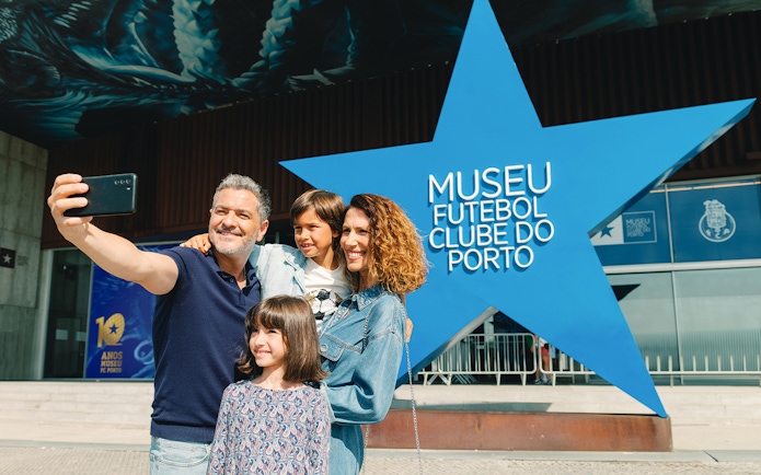 Visitors taking a selfie outside FC Porto Museum entrance.
