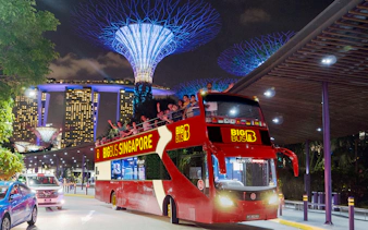 Open-top bus on Singapore Christmas light tour near Marina Bay Sands.
