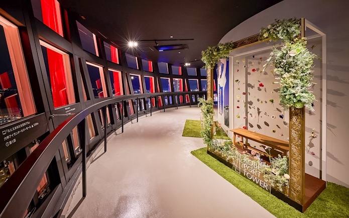 Kobe Port Tower interior with panoramic windows and floral display.