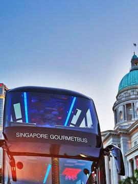 Singapore Gourmet Bus in front of historic building dome.