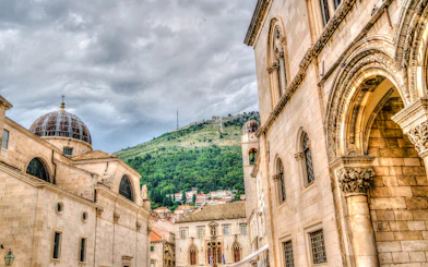Historic architecture in Dubrovnik with hillside view, part of the History Walk & Dubrovnik Panorama by Boat tour.
