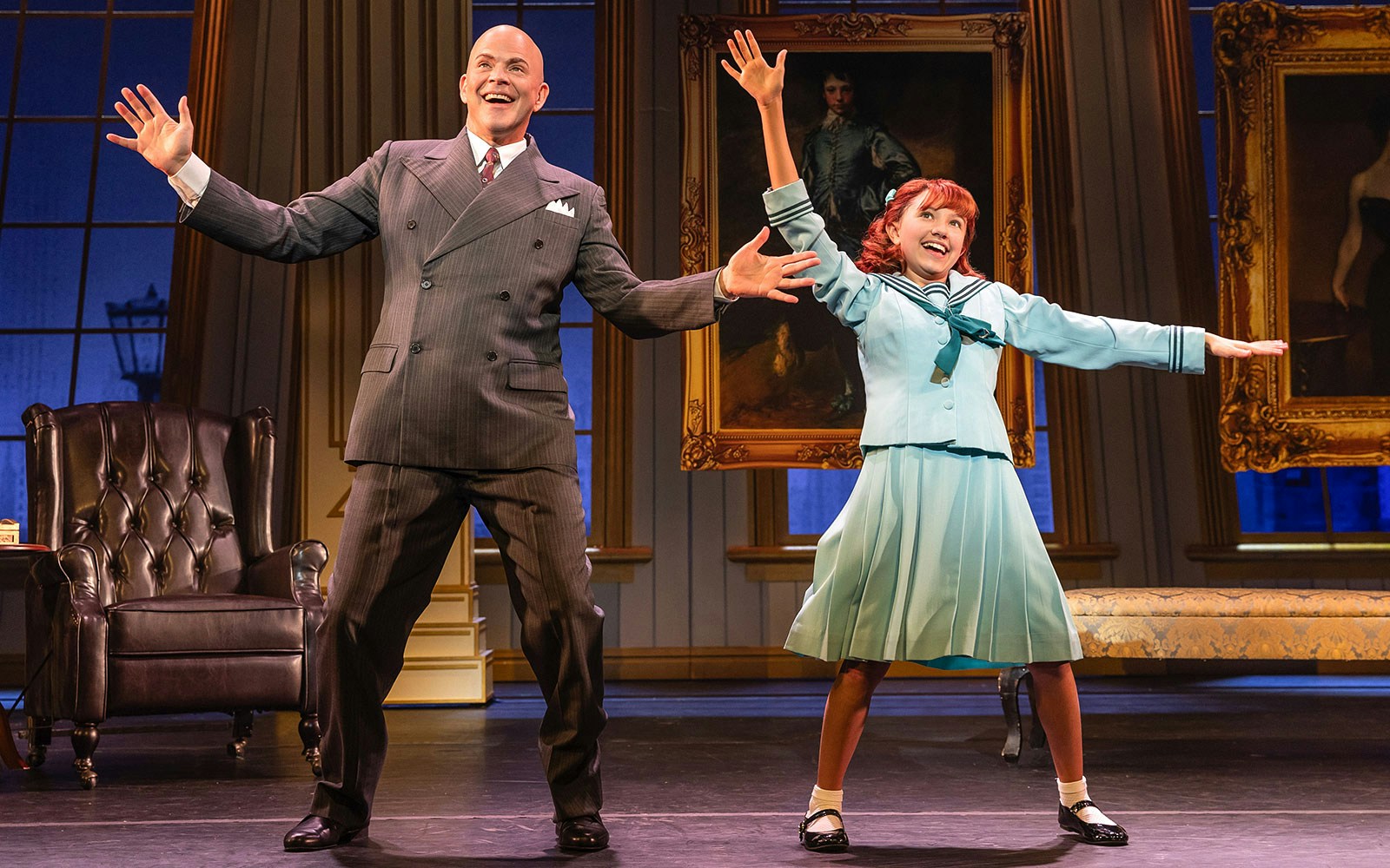 Man and girl performing on stage in a scene from the musical "Annie.