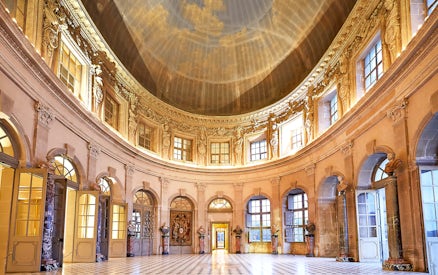 Vaux-le-Vicomte Castle interior with ornate dome and marble columns.