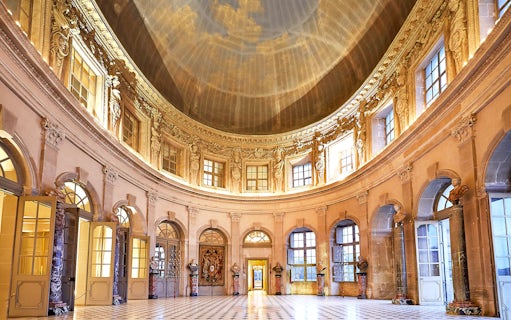 Vaux-le-Vicomte Castle interior with ornate dome and marble columns.