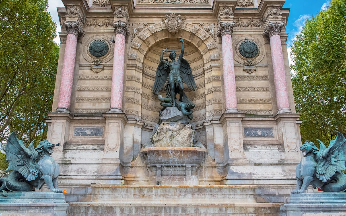 Saint-Michel fountain in Paris with archangel statue and ornate architecture.