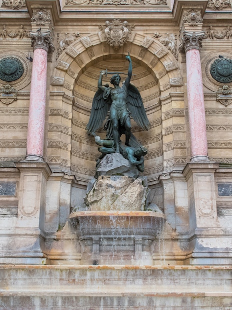 Saint-Michel fountain in Paris with archangel statue and ornate architecture.