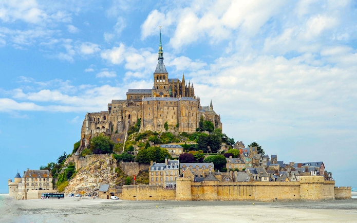 Mont Saint-Michel island with abbey and surrounding village, France.