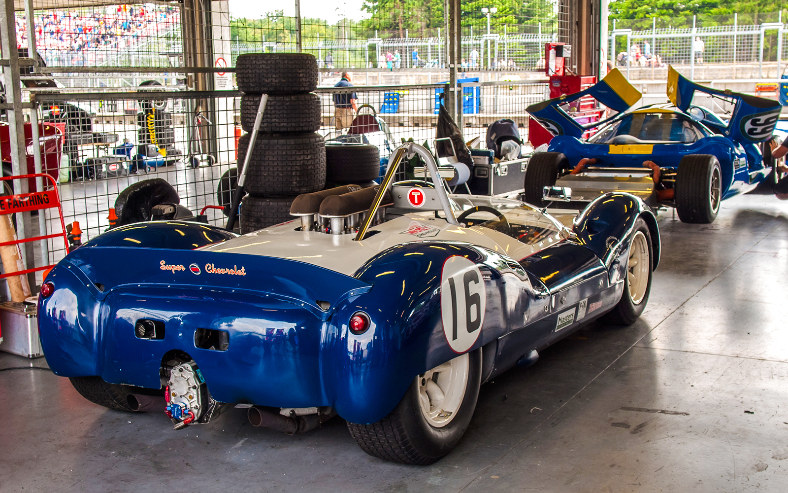 Vintage race cars in a Monaco garage during Formula 1 walking tour.