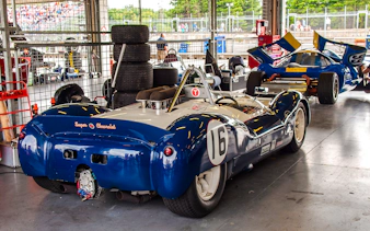 Vintage race cars in a Monaco garage during Formula 1 walking tour.