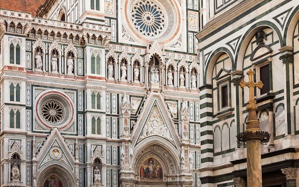 Cathedral facade and Piazza Duomo in Florence with detailed sculptures.